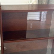 Vintage 1960s wooden library with sliding doors.