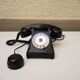 Old ptt phone with rotary dial in black bakelite