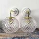 Set of two wall sconces in brass and glass