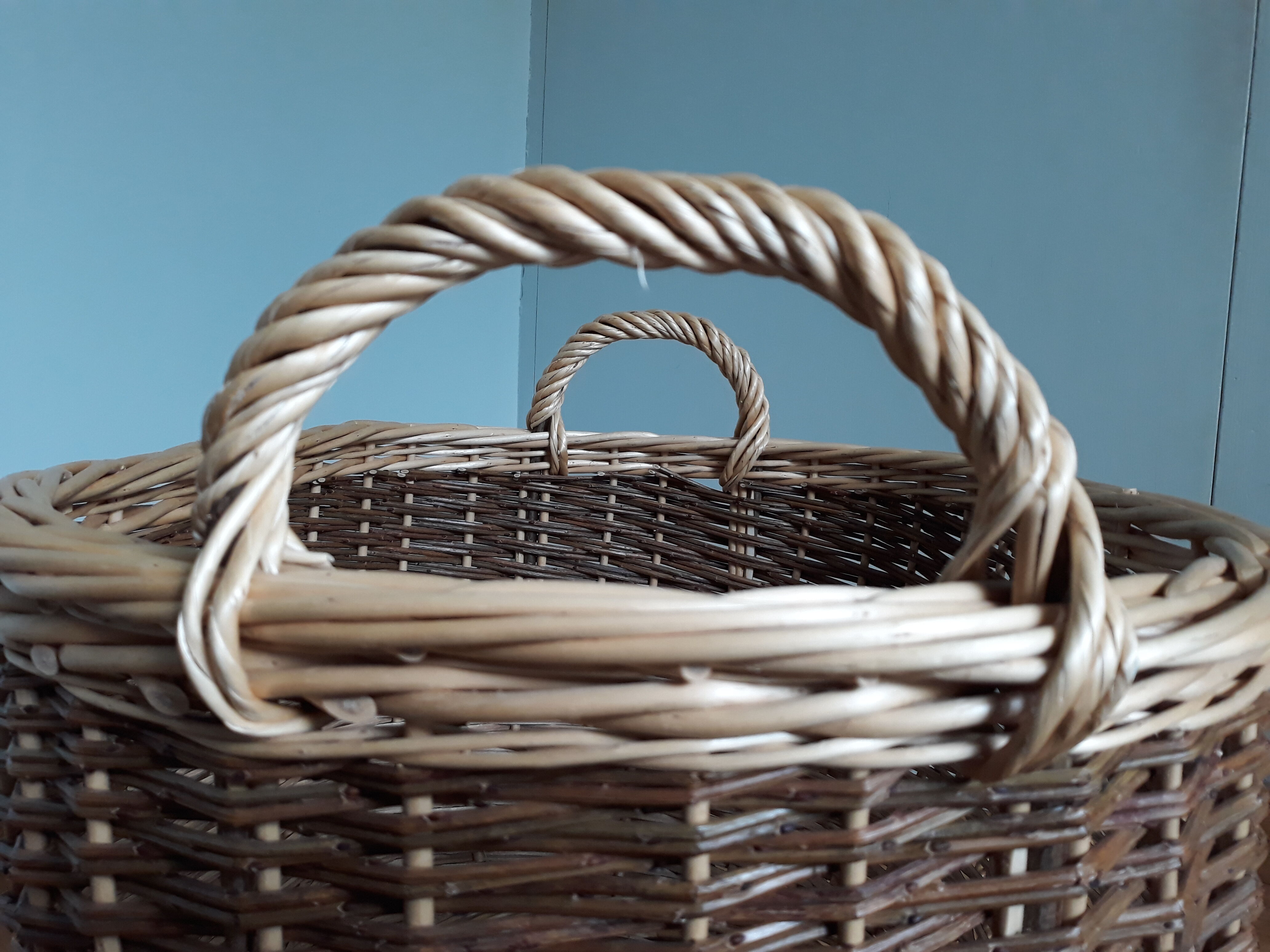 Very large oval laundry basket in two-tone braided wicker with handles