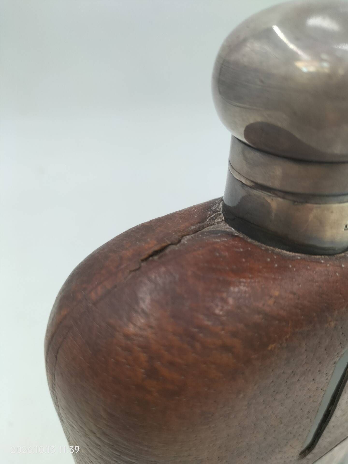 Silver-plated metal flask with leather and glass