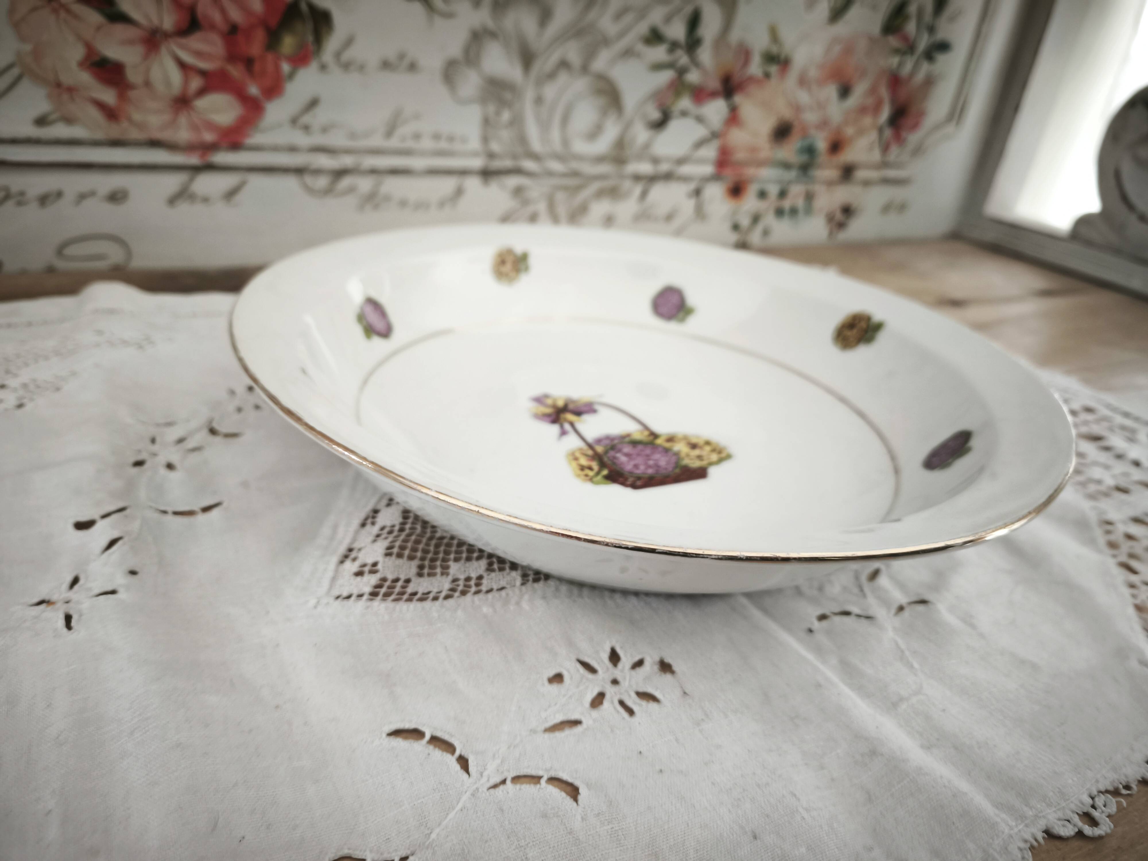 Shallow round plate in Limoges porcelain with a hydrangea basket design.
