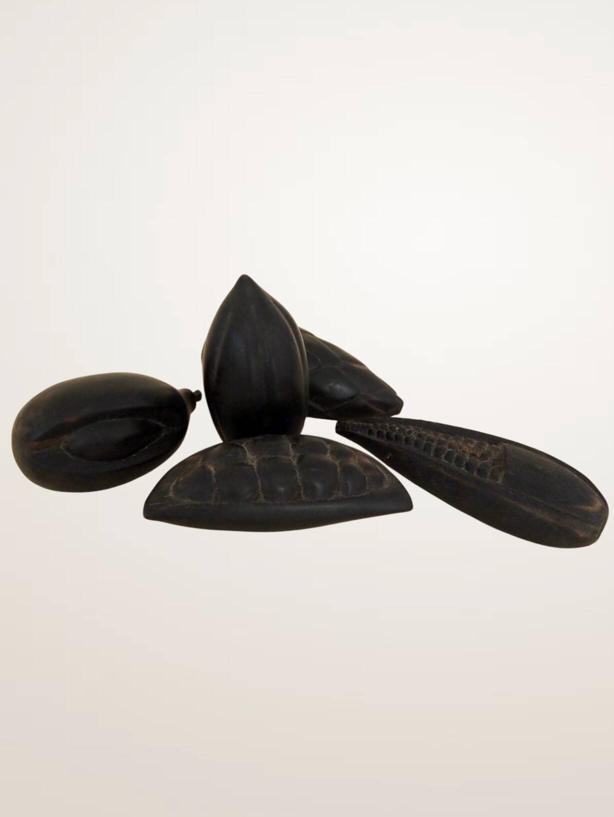 Set of decorative fruits in carved blackened wood.