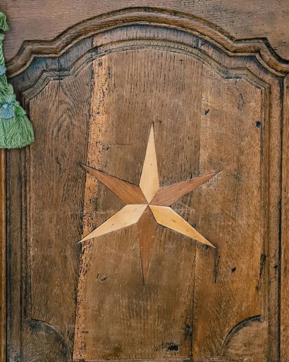 Antique French rustic wardrobe with star inlays.