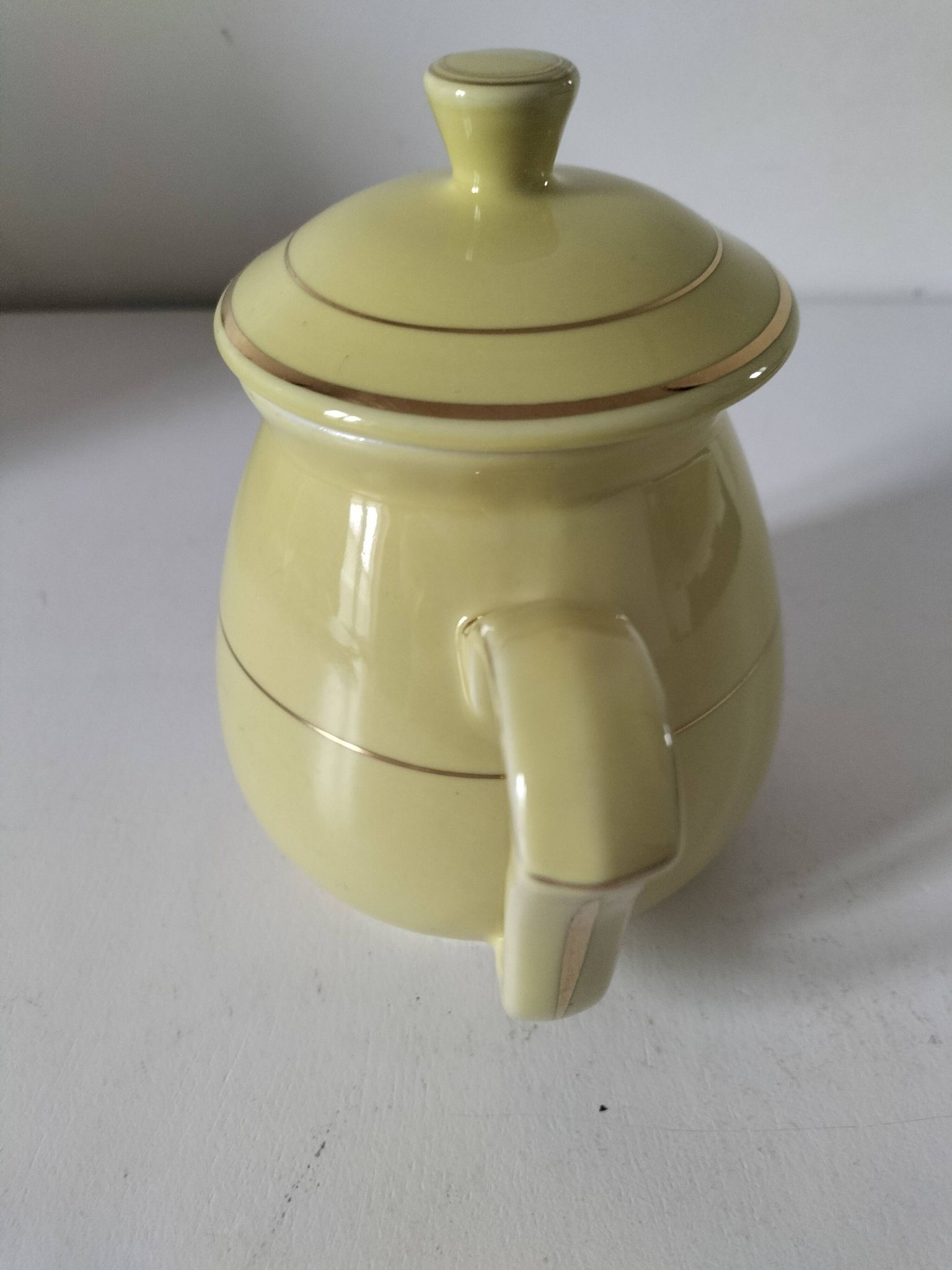Vintage teapot in pastel yellow earthenware with gold trim