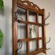 Art Deco wall-mounted coat rack in oak, early 20th century. Beveled central mirror