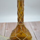 Amber decanter with wicker and golden chain