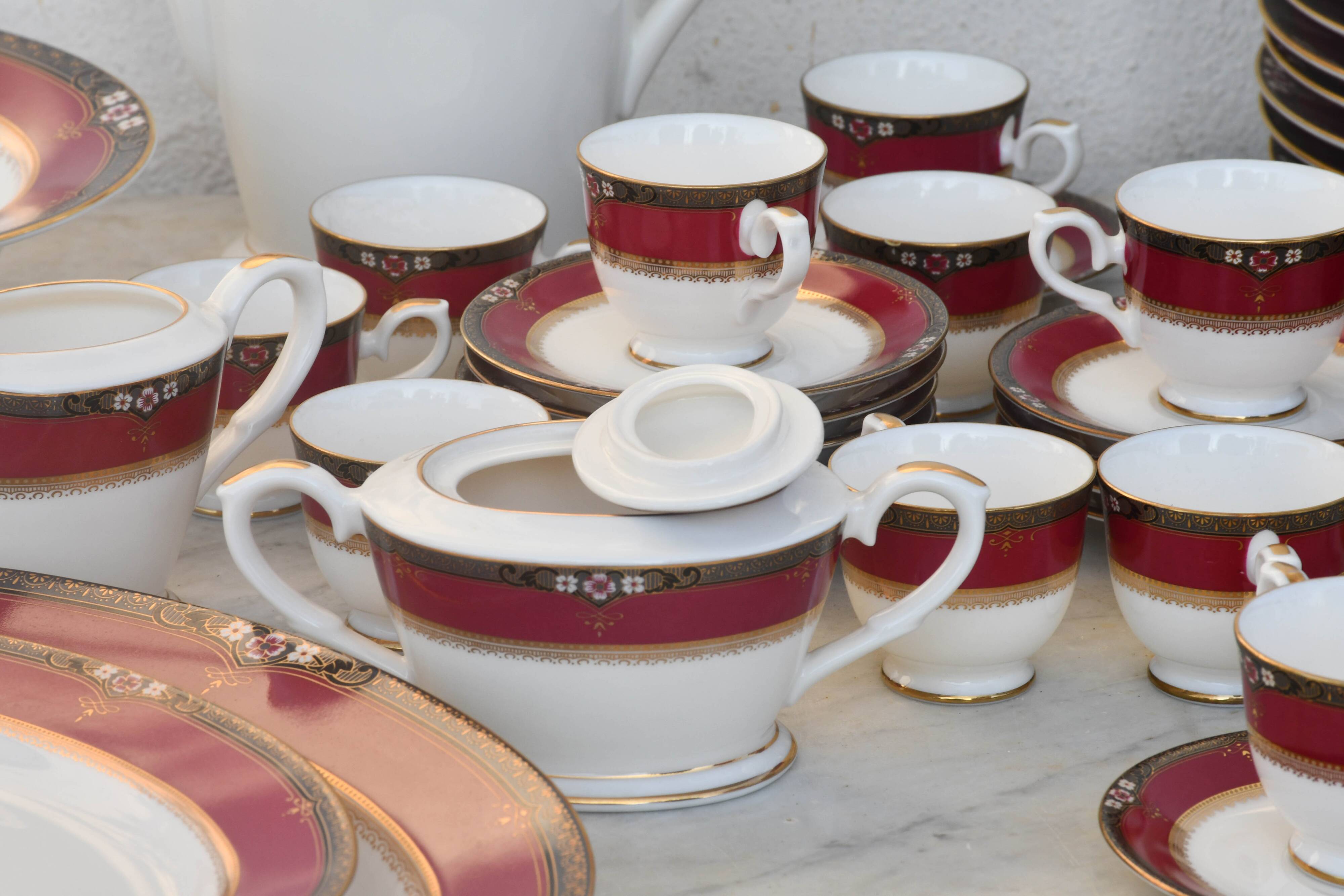 Elegant mid-century Japanese bone china service for 12 in white and noble red