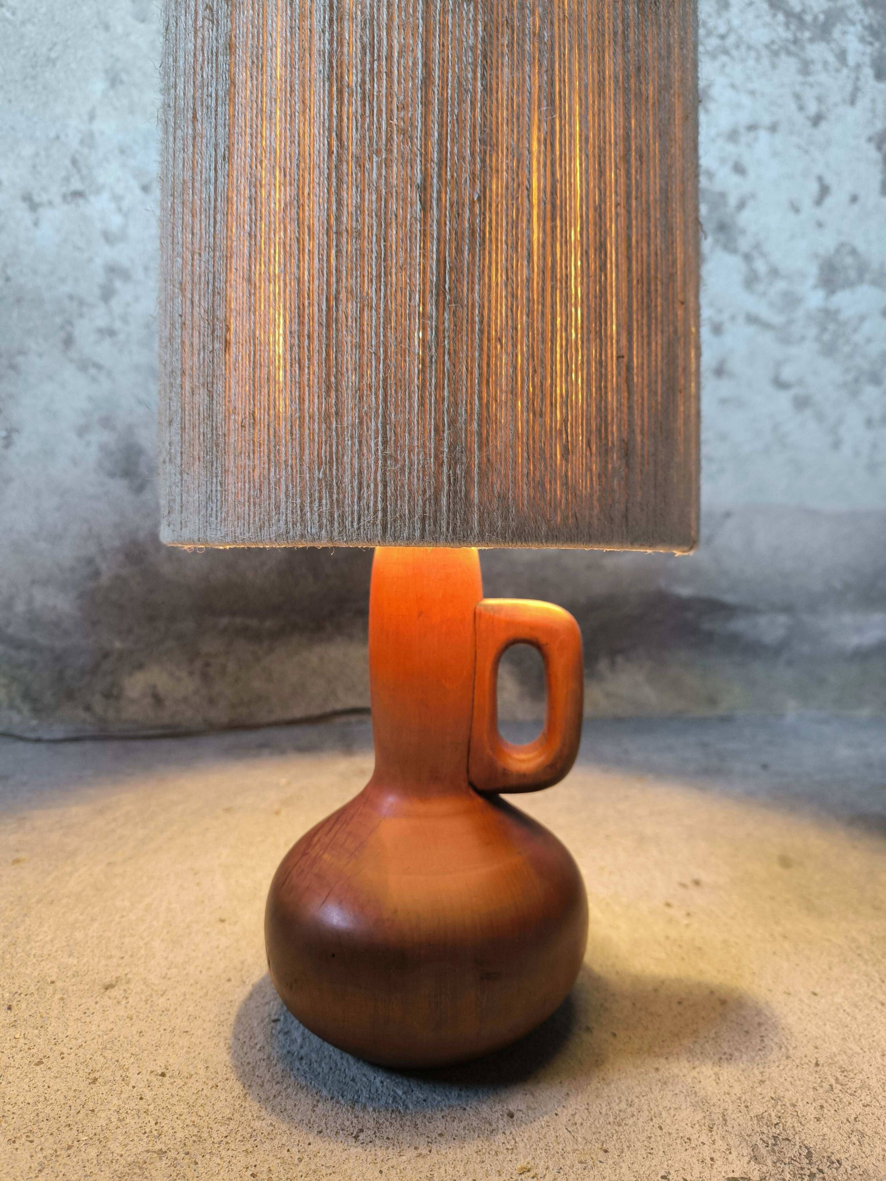 Vintage wooden table lamp with a wool shade.