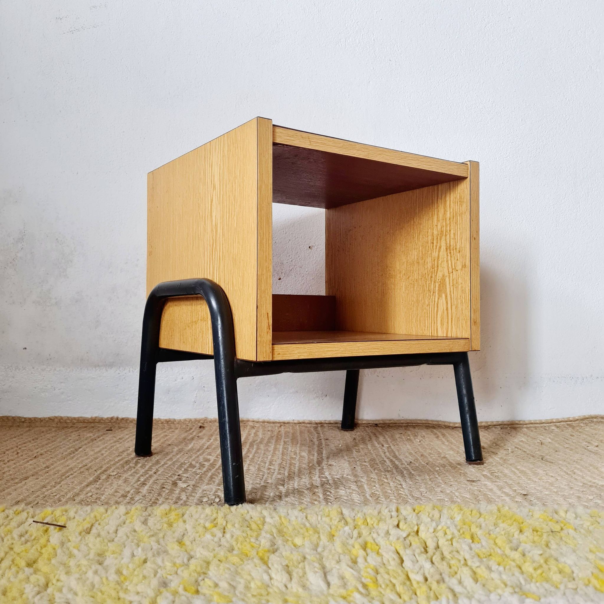 Bedside table - small wooden piece of furniture with a tubular metal base.