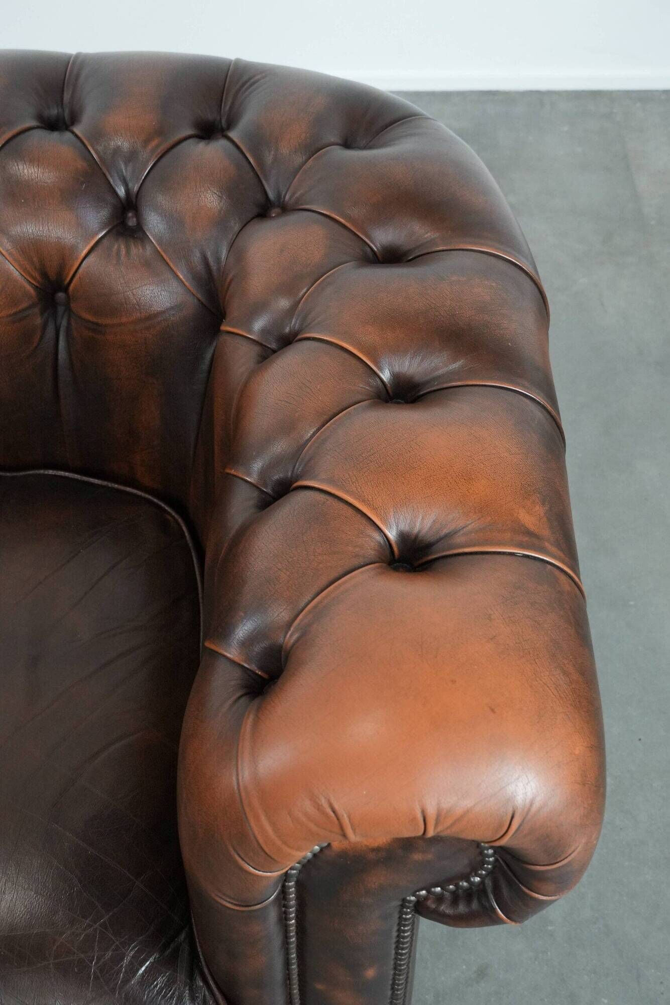 Brown Chesterfield armchair made of cowhide leather in English style