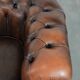 Brown Chesterfield armchair made of cowhide leather in English style