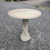 Cement garden table with trunk-shaped foot