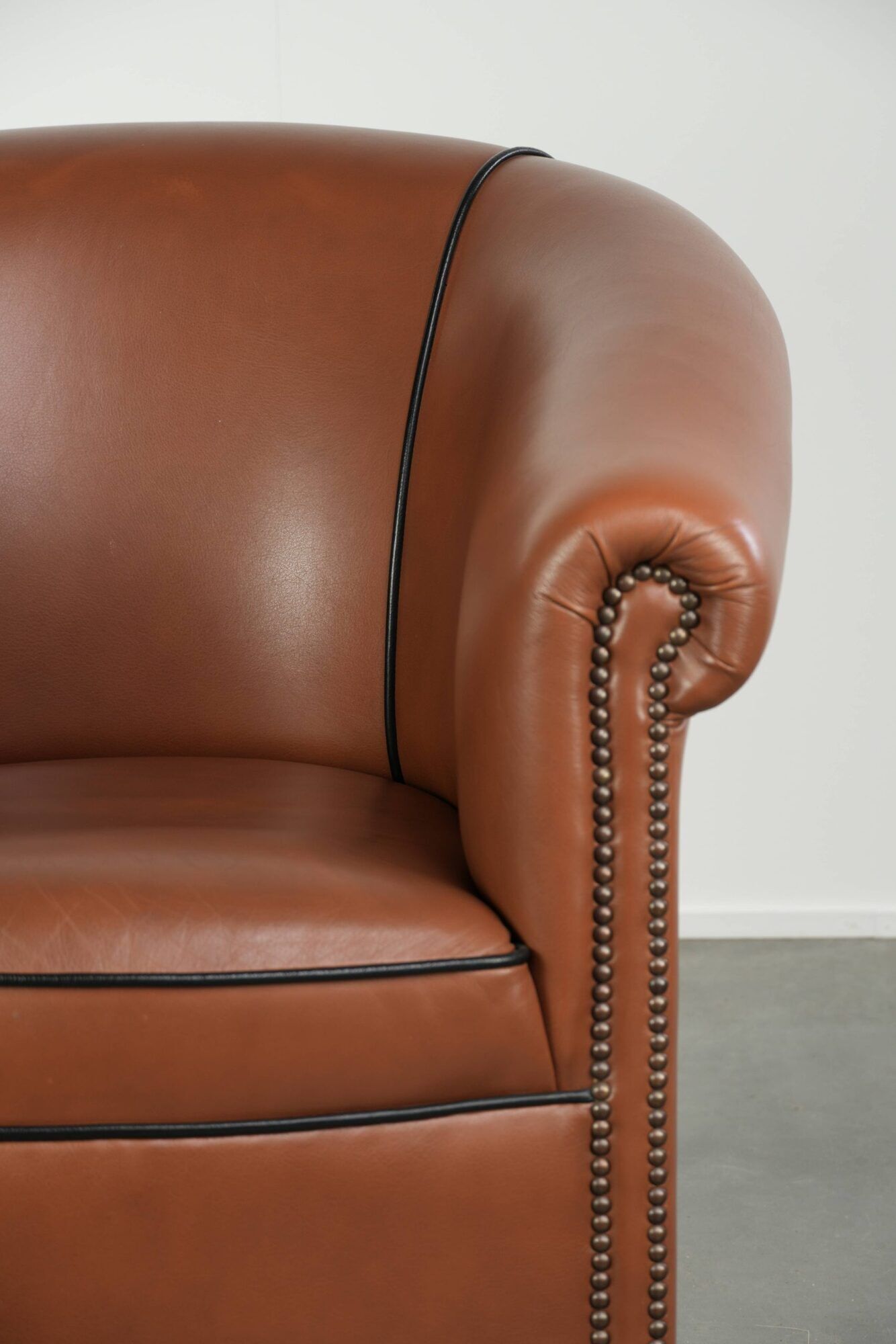 Cowhide club armchair in English style with comfortable seating.