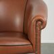 Cowhide club armchair in English style with comfortable seating.