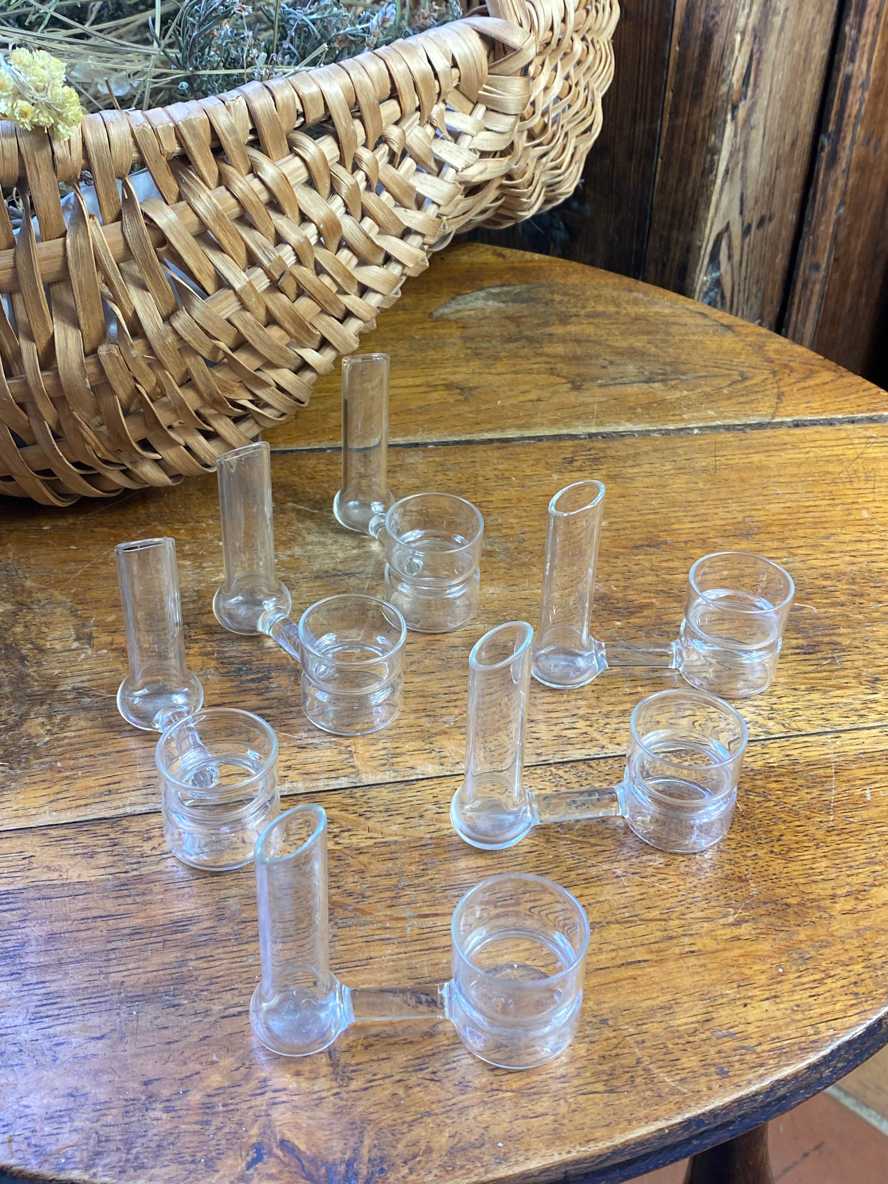 Knife rests, flower vases and candle holders in blown glass.