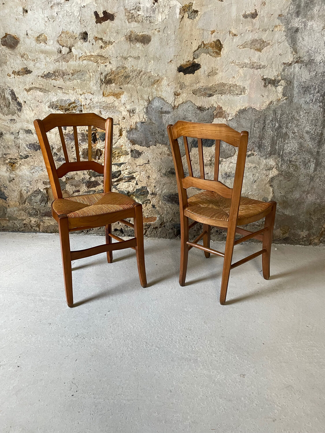 Set of 2 antique wooden and straw chairs.