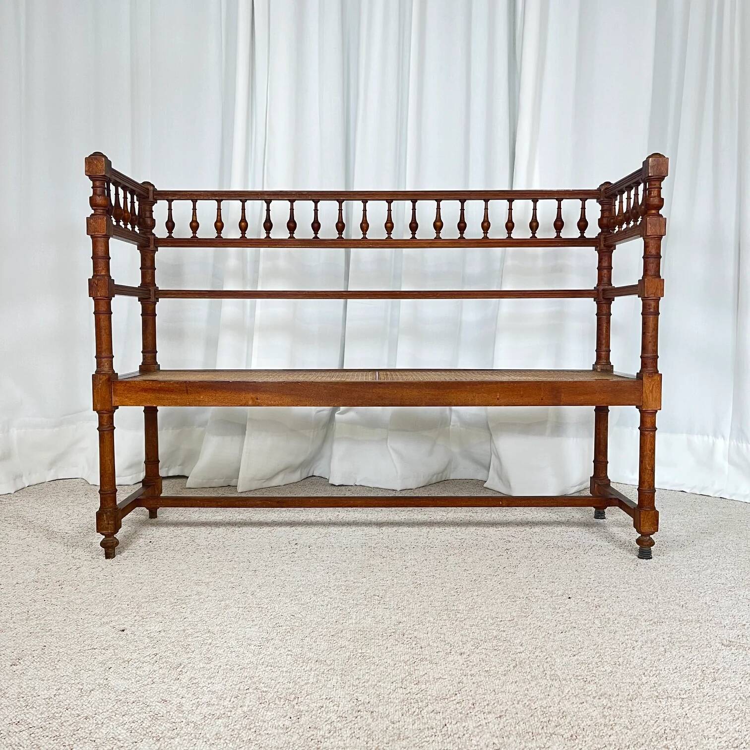 Antique banquette in Louis XIII style, turned wood with caning, late 19th to early 20th century.