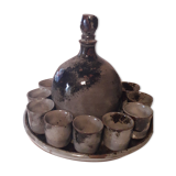 Ceramic liquor service with a decanter and 12 small glasses on tray