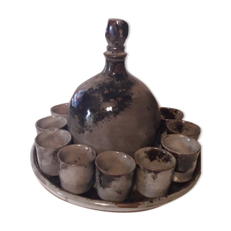 Ceramic liquor service with a decanter and 12 small glasses on tray