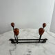 Wall-mounted coat rack in wrought iron with turned wooden knobs.