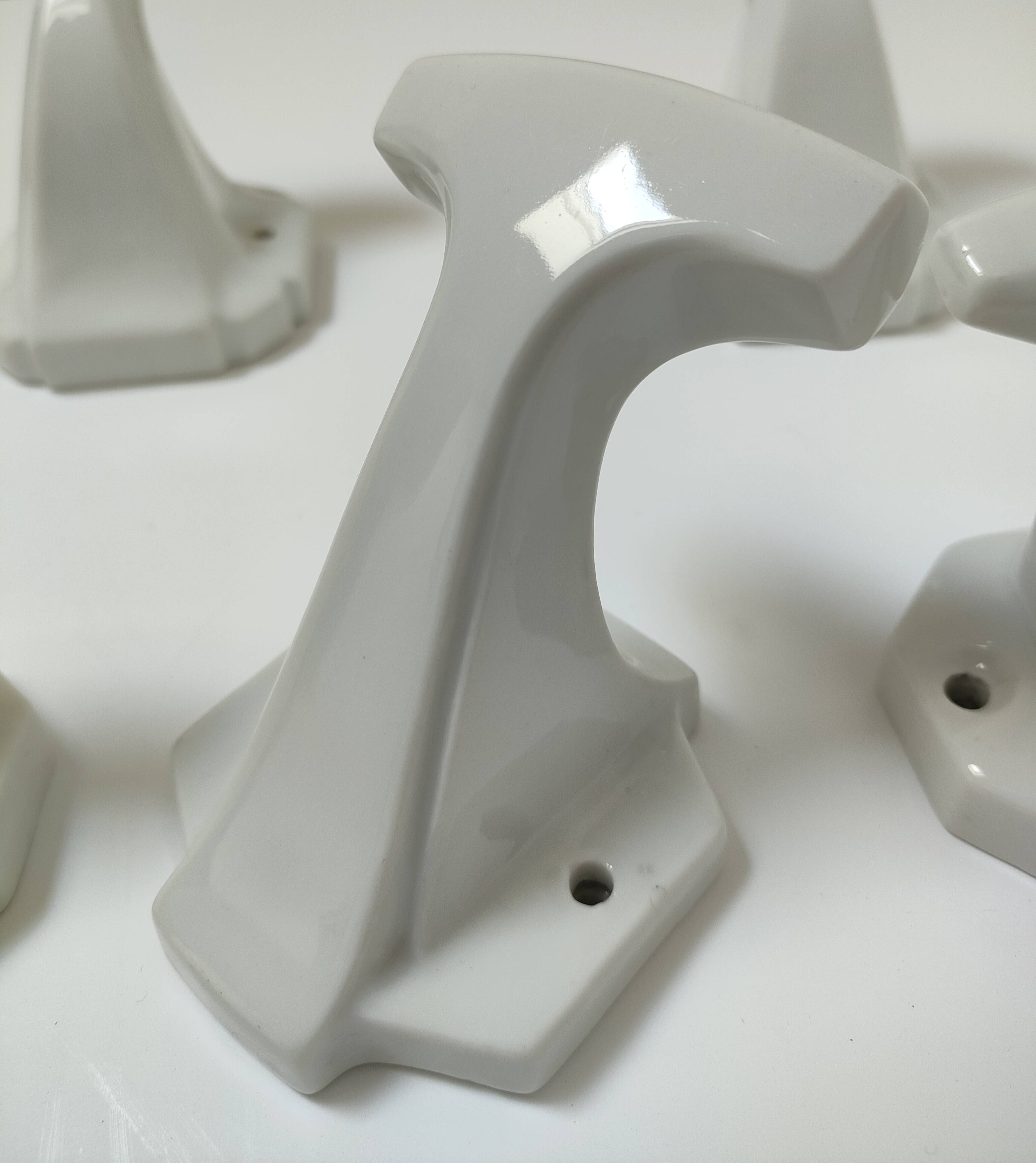 Five art deco white porcelain hooks