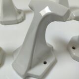 Five art deco white porcelain hooks