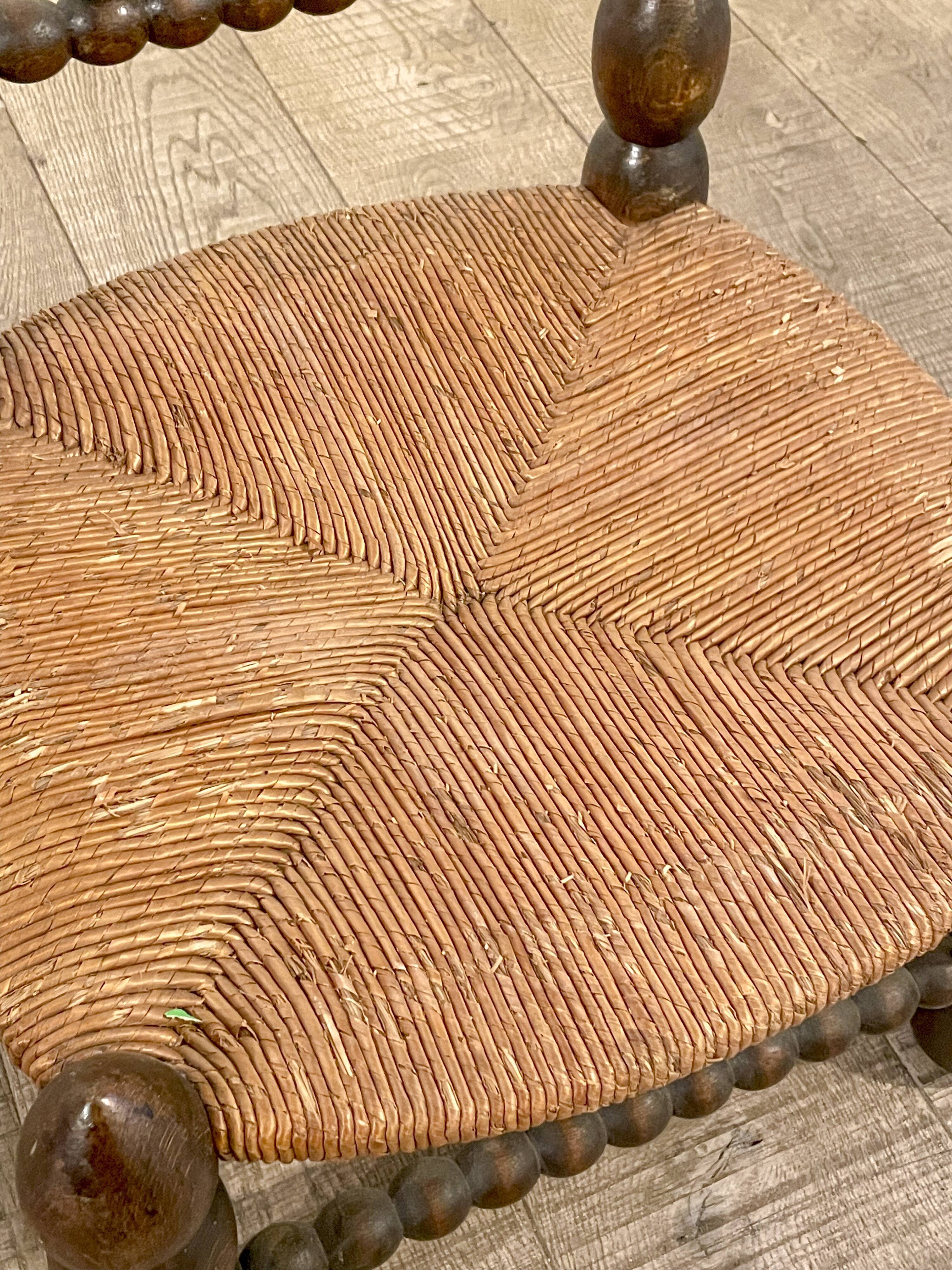 Low chair in beaded wood and straw