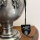 Ewer in pewter surrounded by vine branches with g