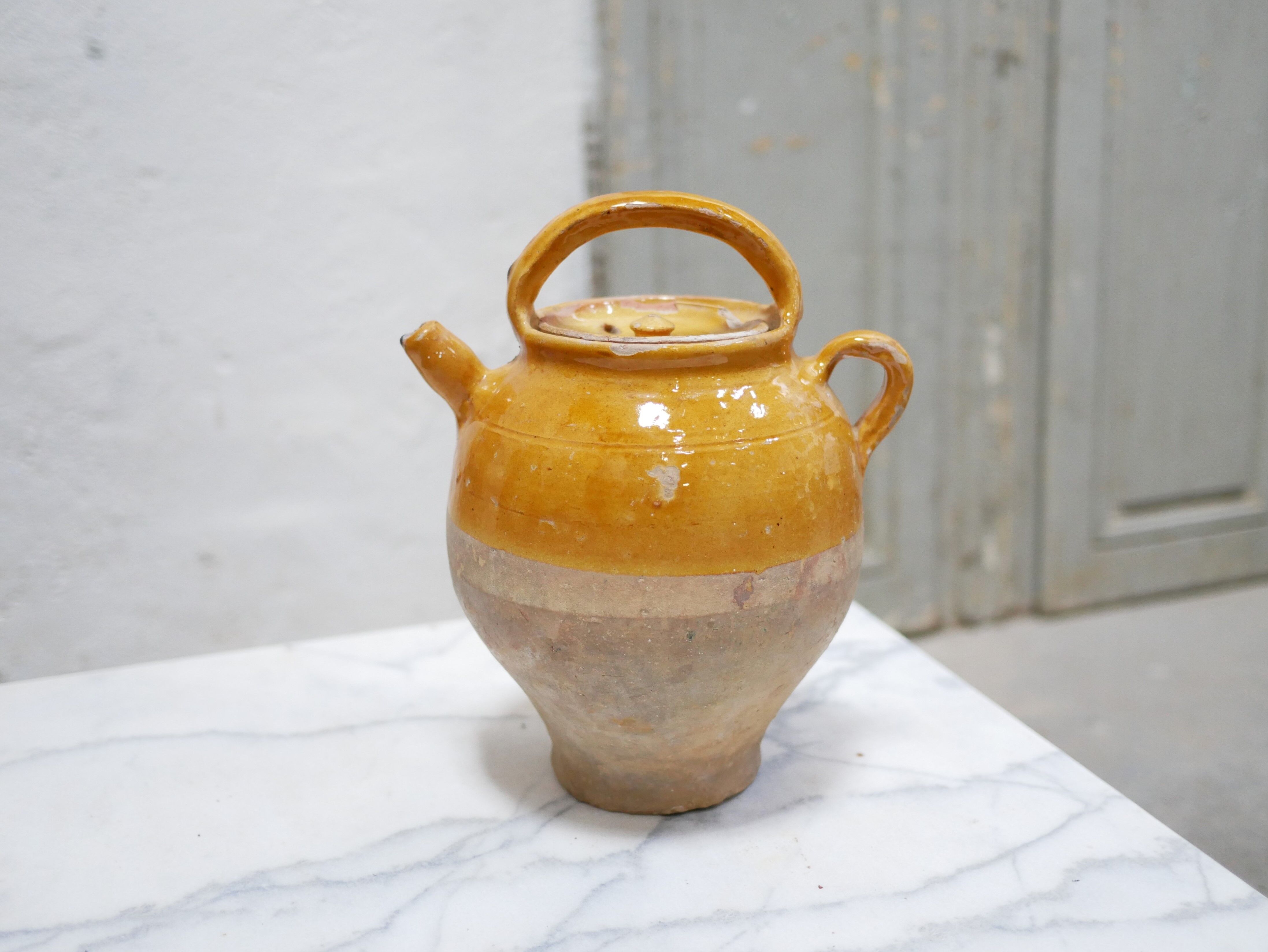 Old gargoulette pot in glazed terracotta