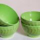 Four vintage spring green earthenware bowls