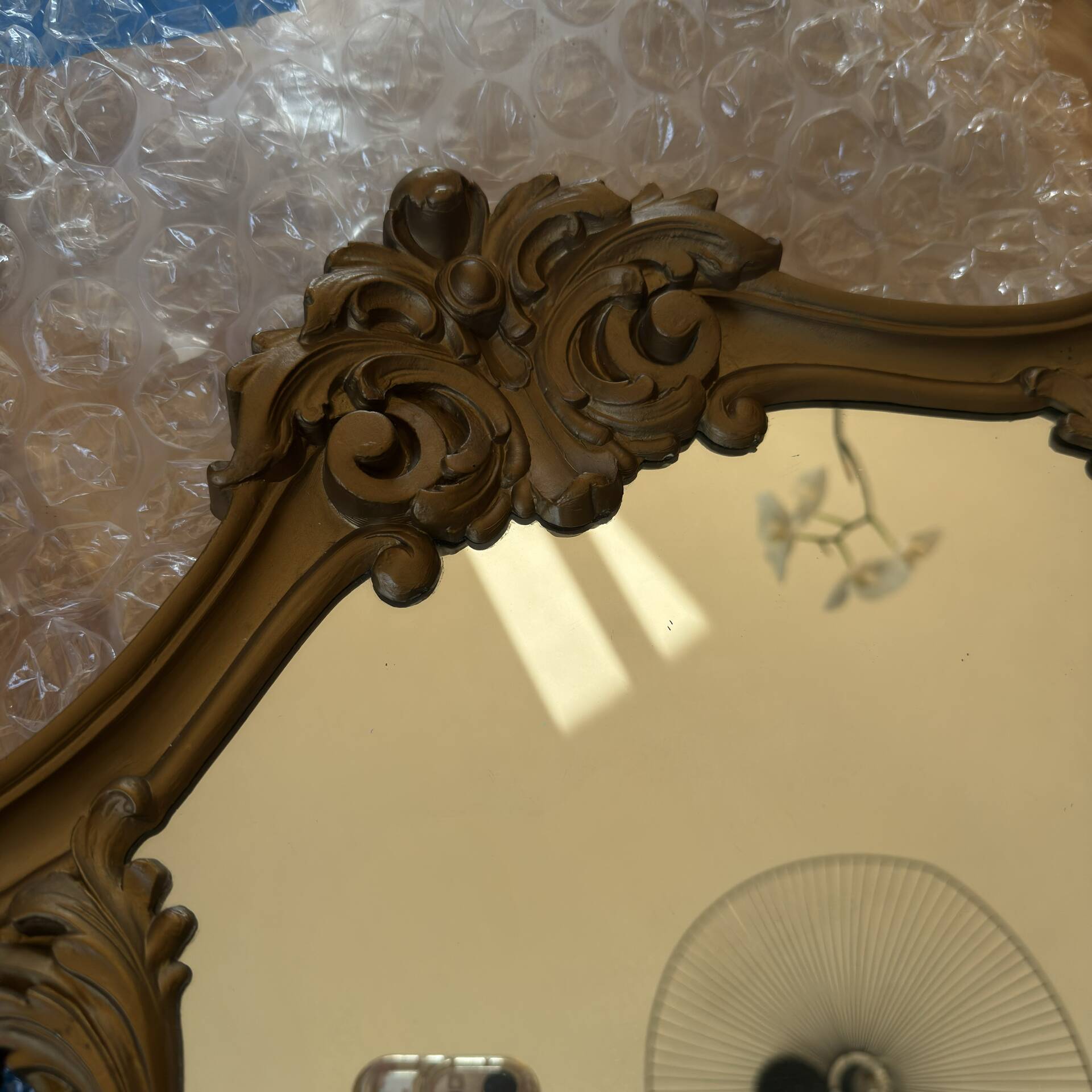 Antique mirror in Louis XV Rocaille style with carved frame.