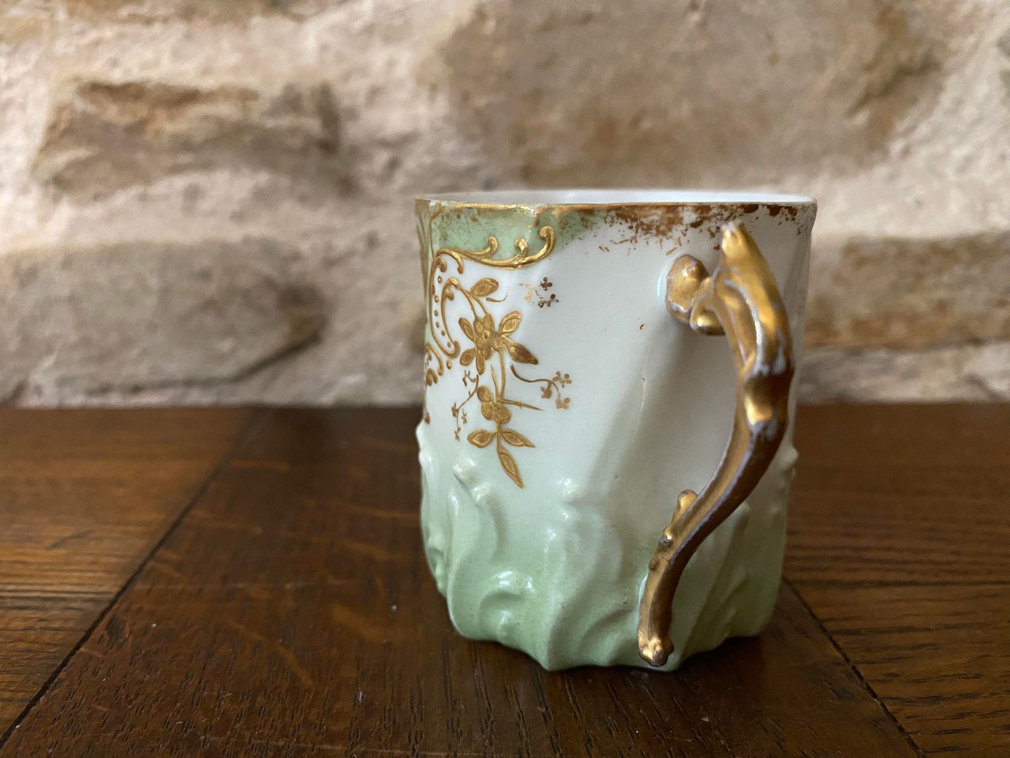 Extra fine porcelain cup pale green decorations and gilding