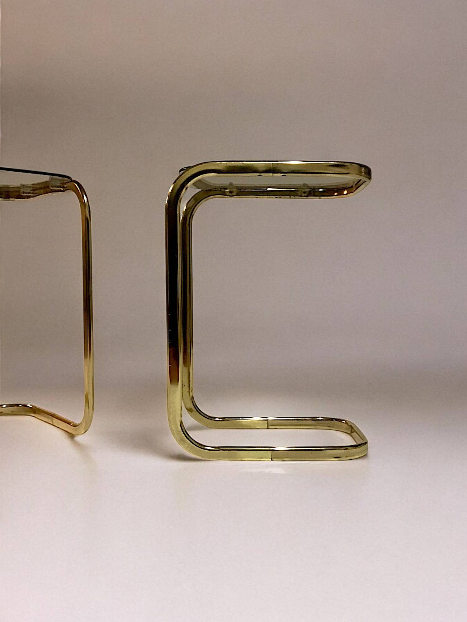 C. 1970 - Pair of side tables in gilded metal and smoked glass -