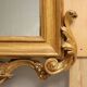 Eclectic antique mirror in carved and gilded wood, Italy, 19th century.