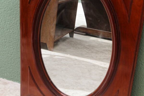 Miroir ovale en verre biseauté et acajou massif