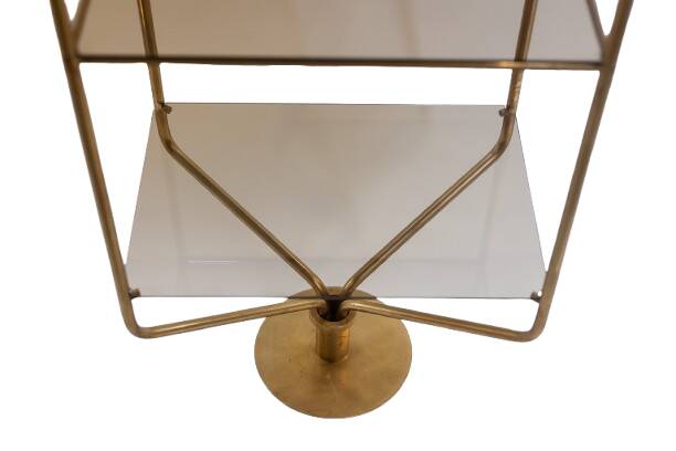 Free-standing shelf in gilded brass with smoked glass shelves. 1970s.