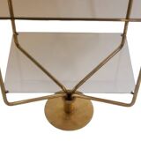 Free-standing shelf in gilded brass with smoked glass shelves. 1970s.