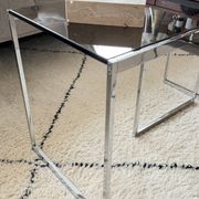 Set of 2 vintage nesting coffee tables in chrome metal and smoked glass.