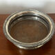 Antique silver-plated bottle coaster with floral decoration.