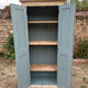 Small antique wardrobe with a faded white patina.