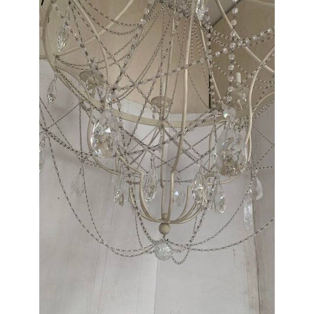 Contemporary ivory florentine iron and crystals chandelier