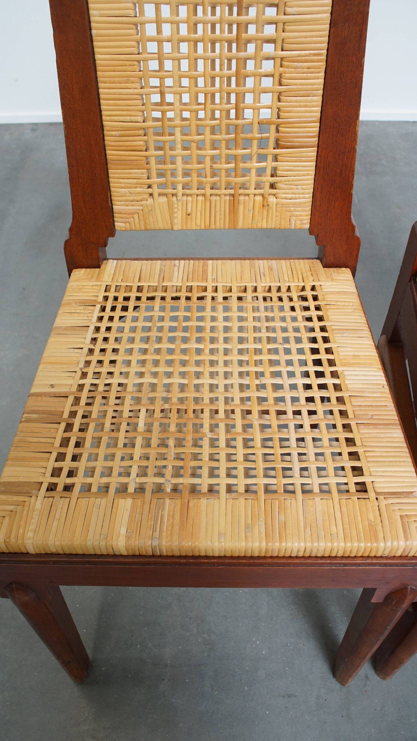 4 wooden Art Deco design dining chairs with a wicker seat and backrest