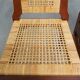 4 wooden Art Deco design dining chairs with a wicker seat and backrest