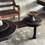 Small antique Indonesian bench in carved teak with plant and floral motifs.