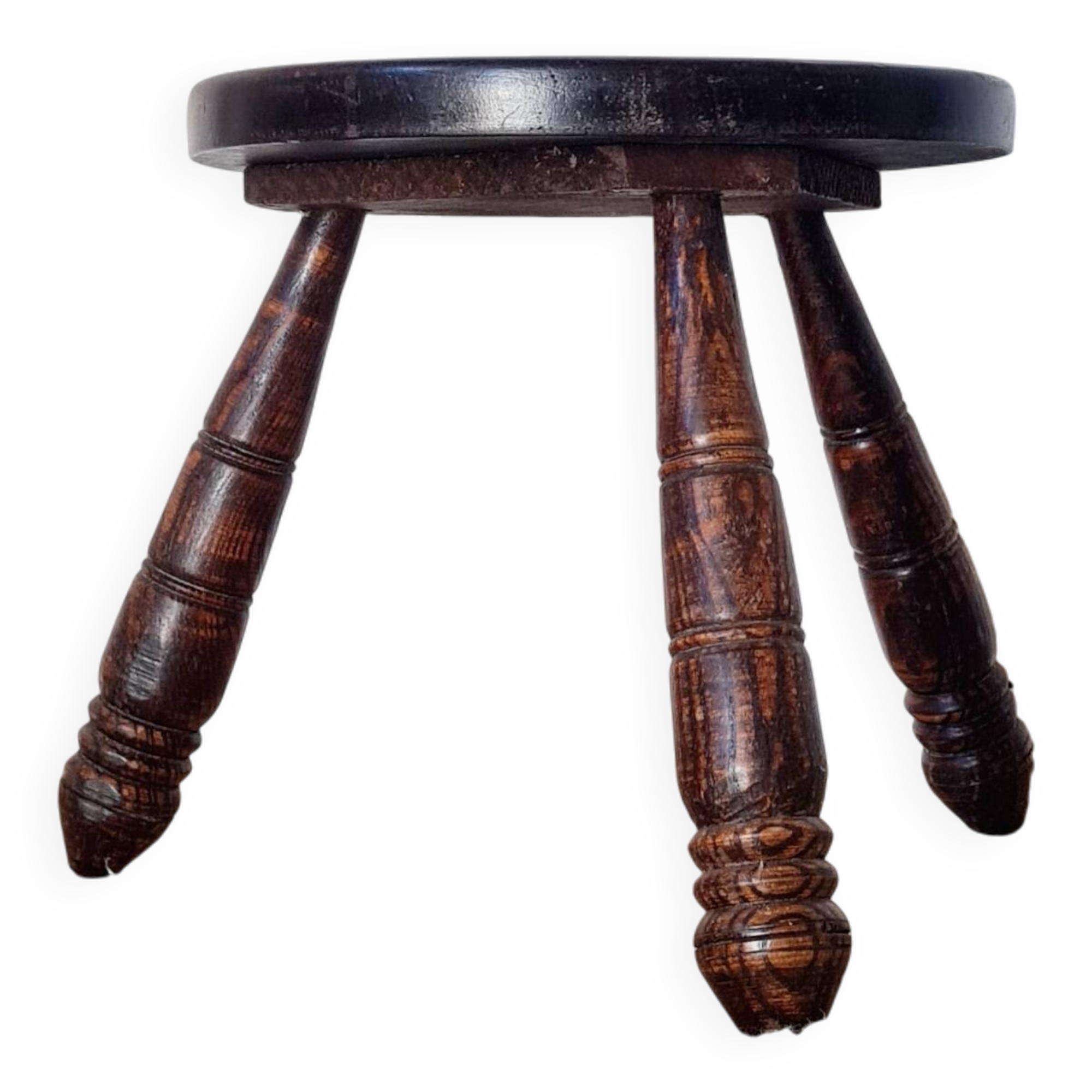 Small brutalist tripod stool made of turned wood.