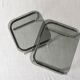 Pair of nesting tables in smoked glass and chrome legs.