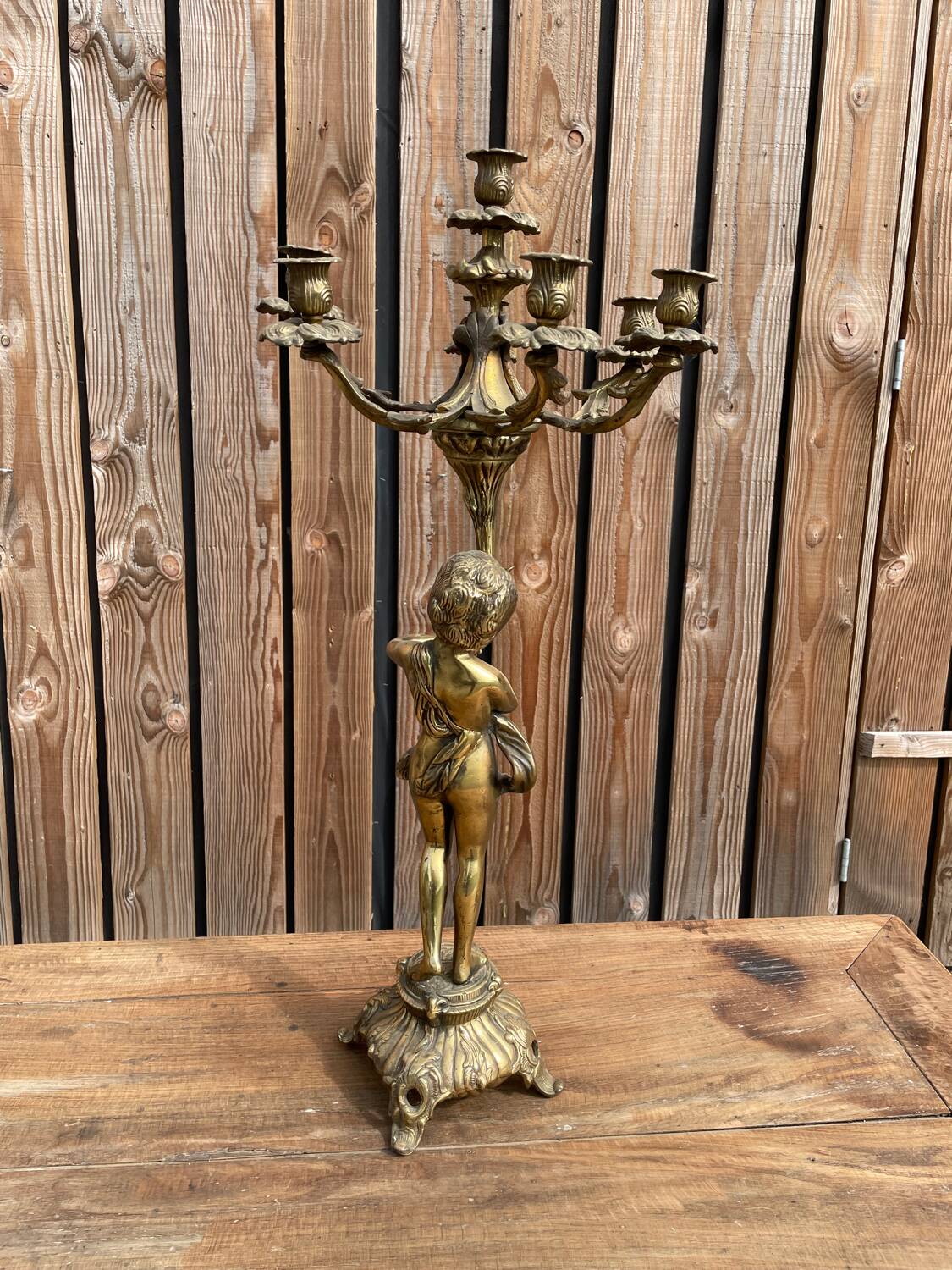 Large bronze candle holder with putti angel