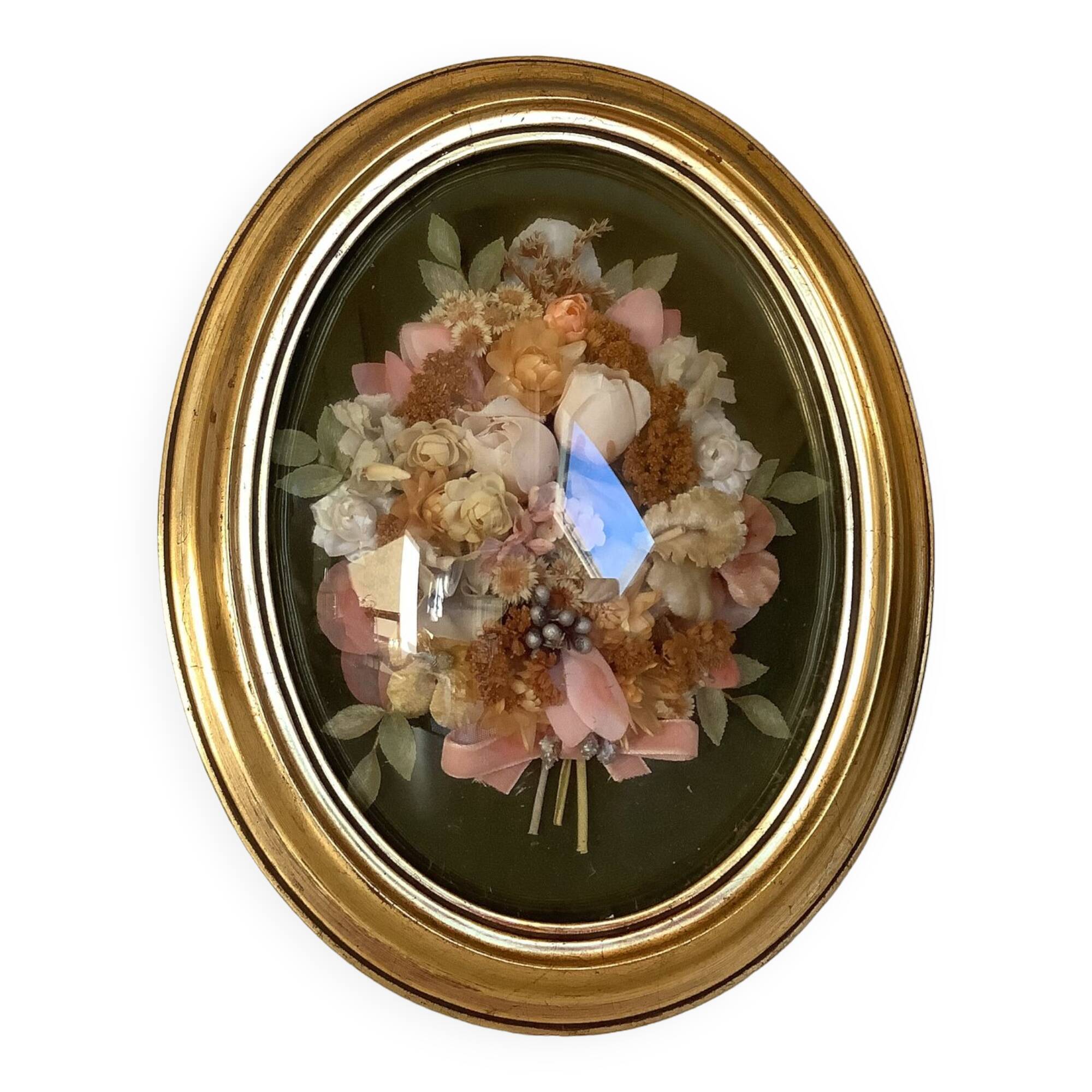 Golden oval frame dried flowers