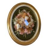 Golden oval frame dried flowers